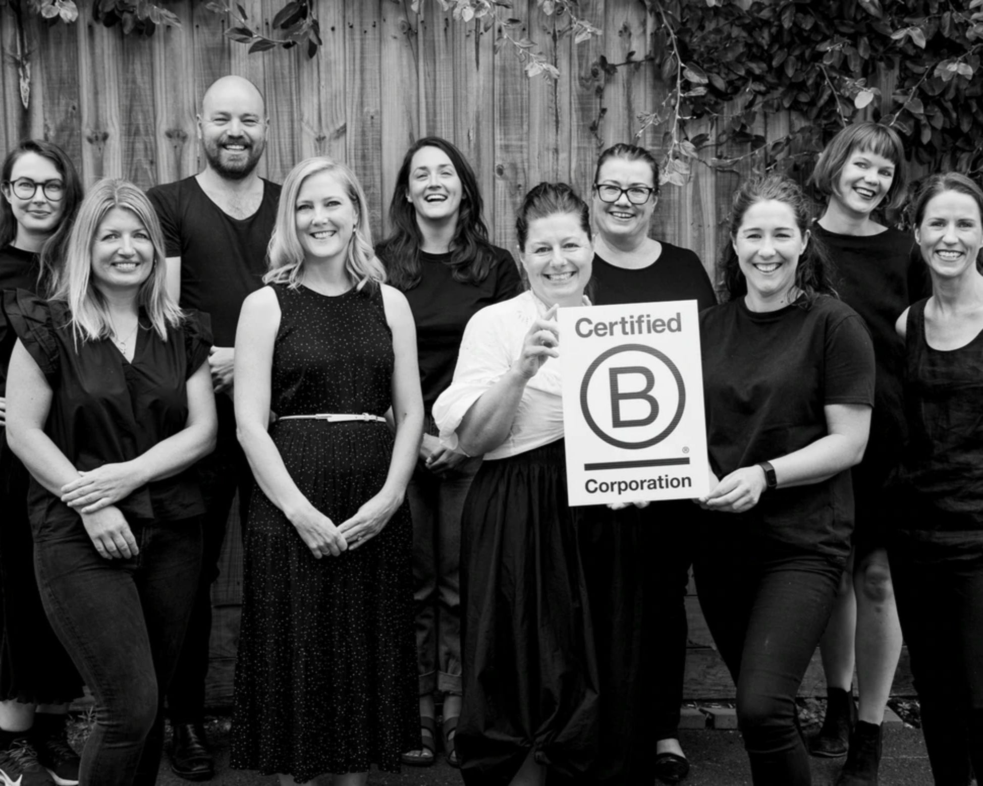 Image of a team of people with b-corp poster for Bindle gift hamper business
