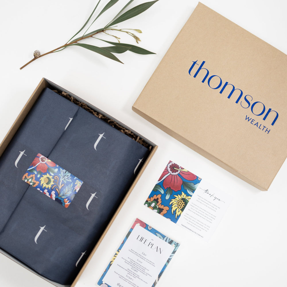Custom-branded corporate gift hampers with Thomson Wealth logo and sustainable packaging