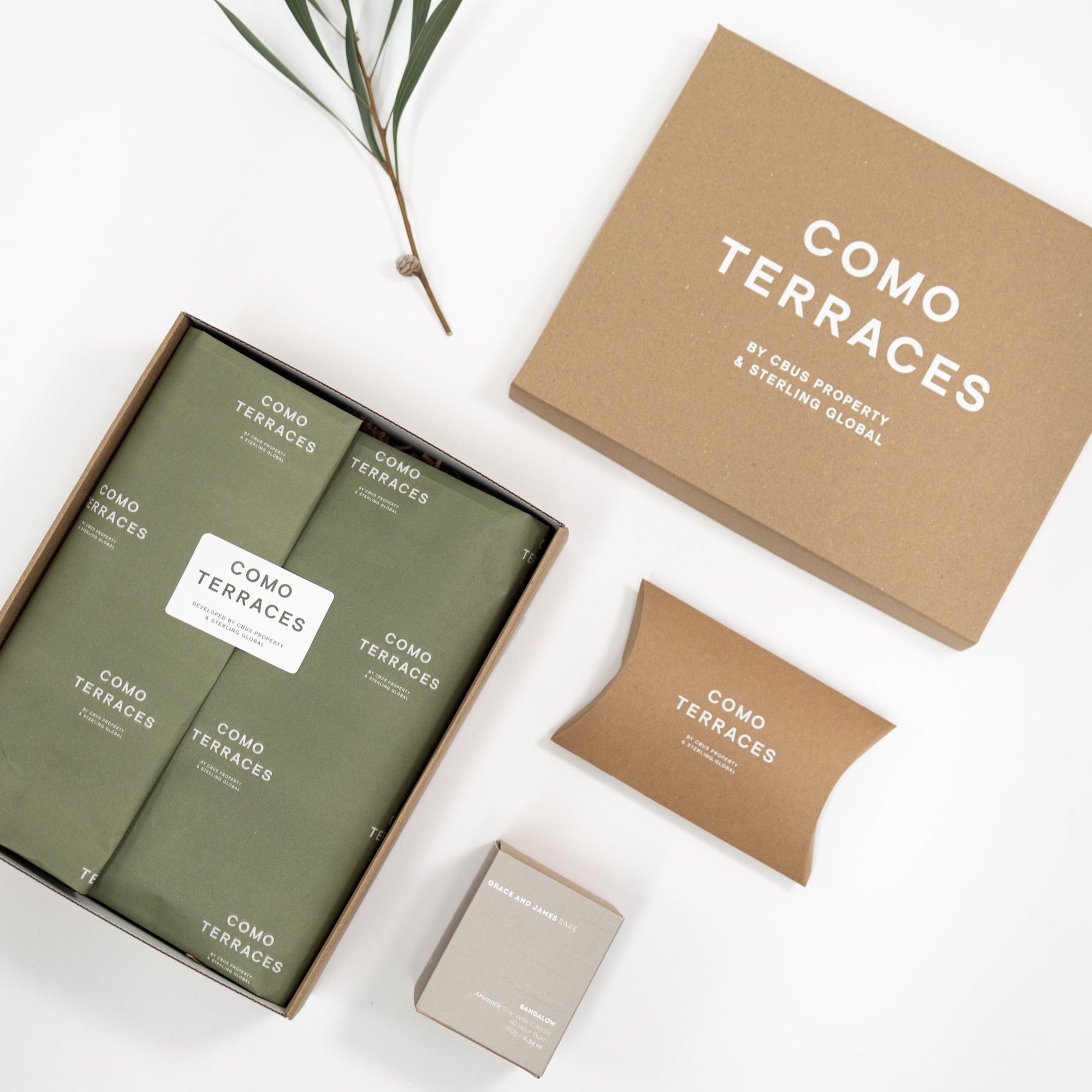 Product packaging for Como Terraces with green boxes and brown packaging on a white background for Bindle Custom Corporate Hamper Gift