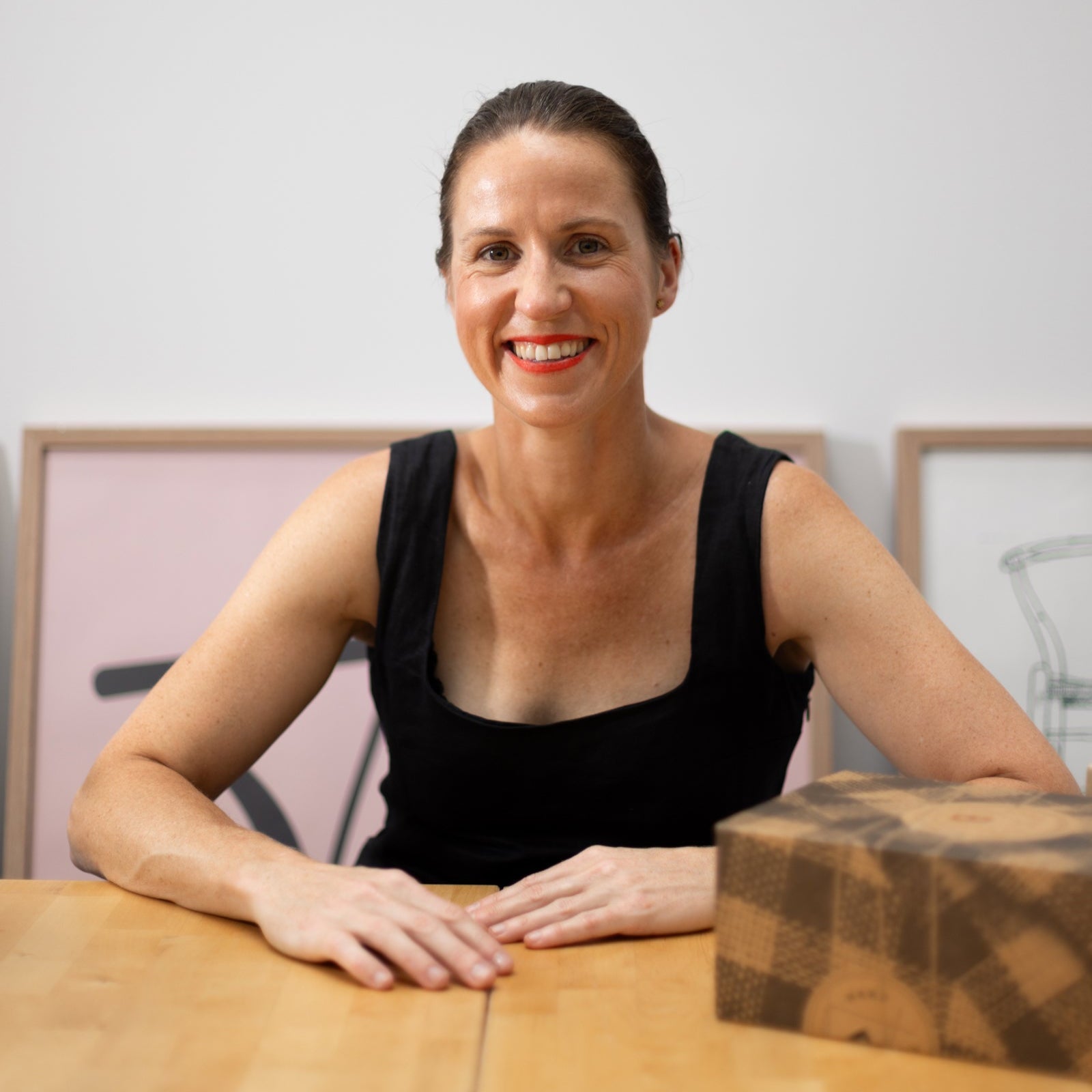 image of smiling woman with bindle gift hamper box