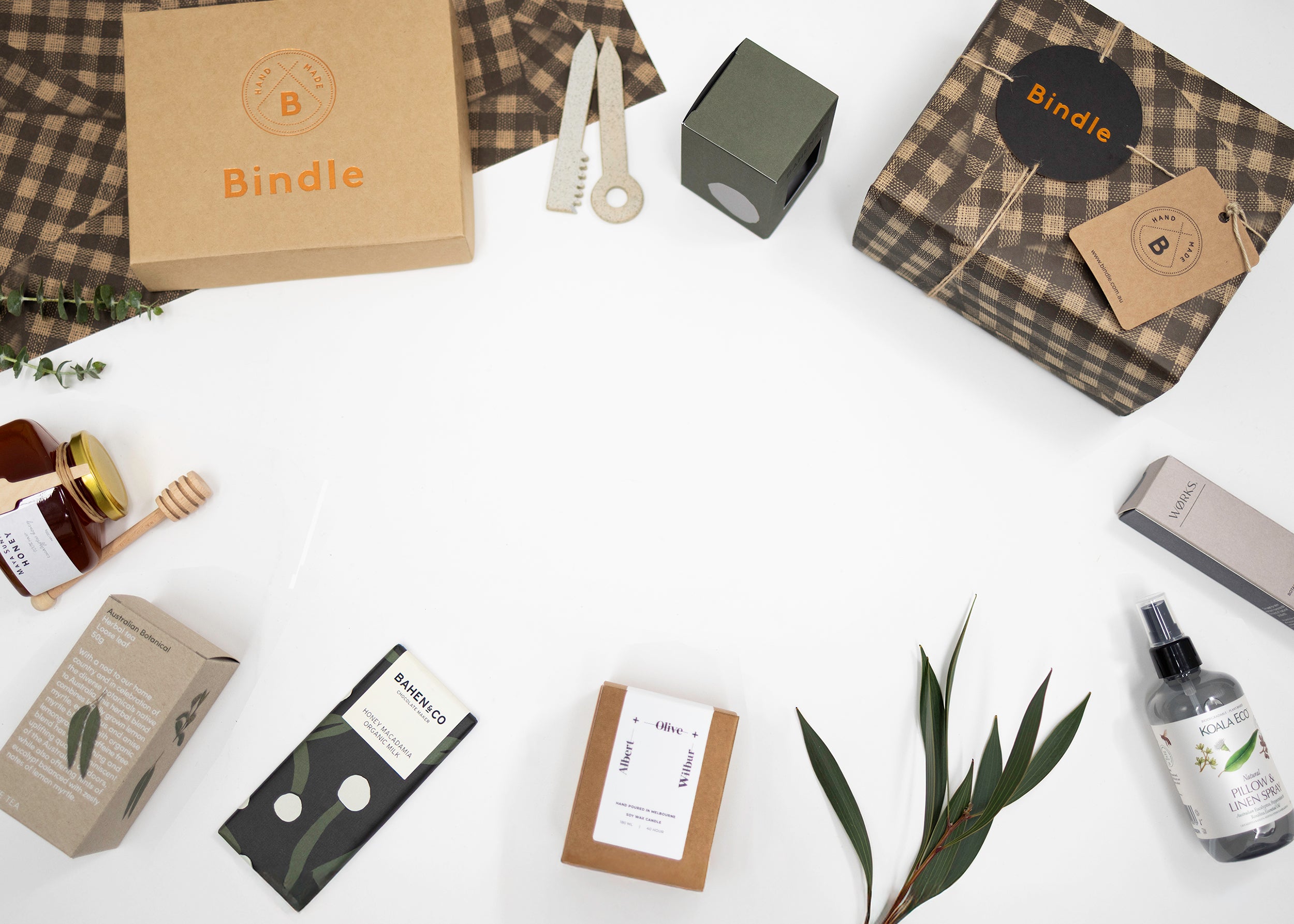 Bindle gift hamper with artisan products and dried florals on linen backdrop