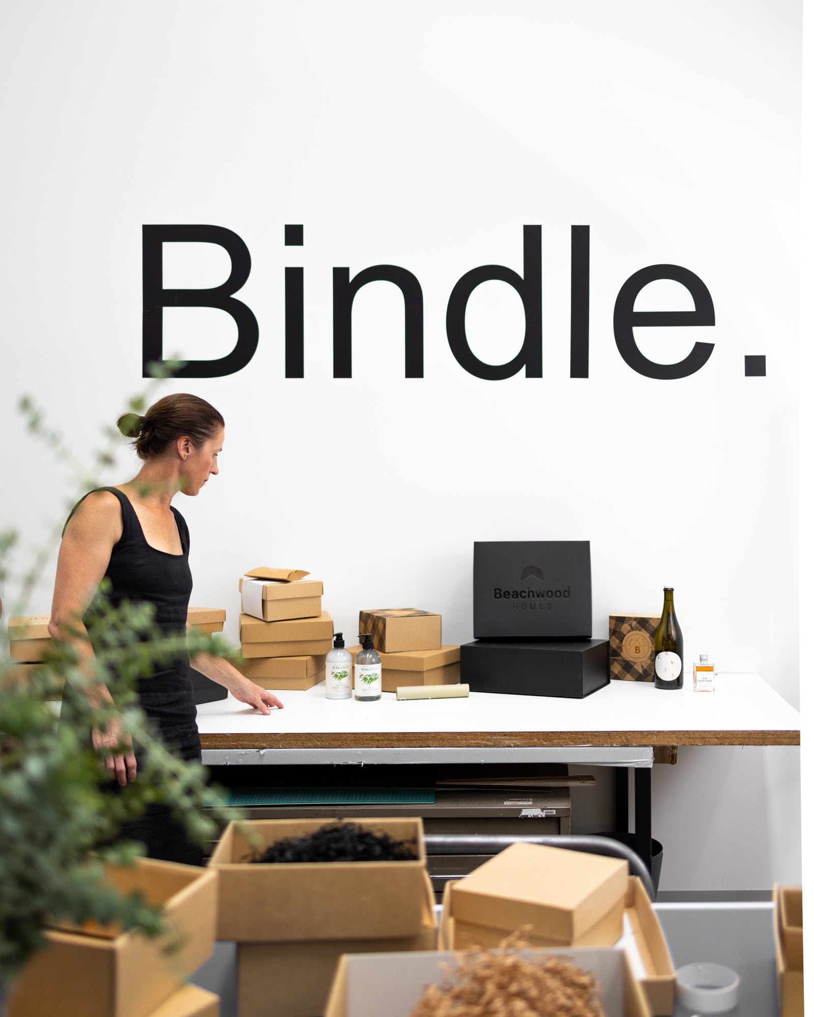 Image of woman in the Bindle office with gift hamper boxes