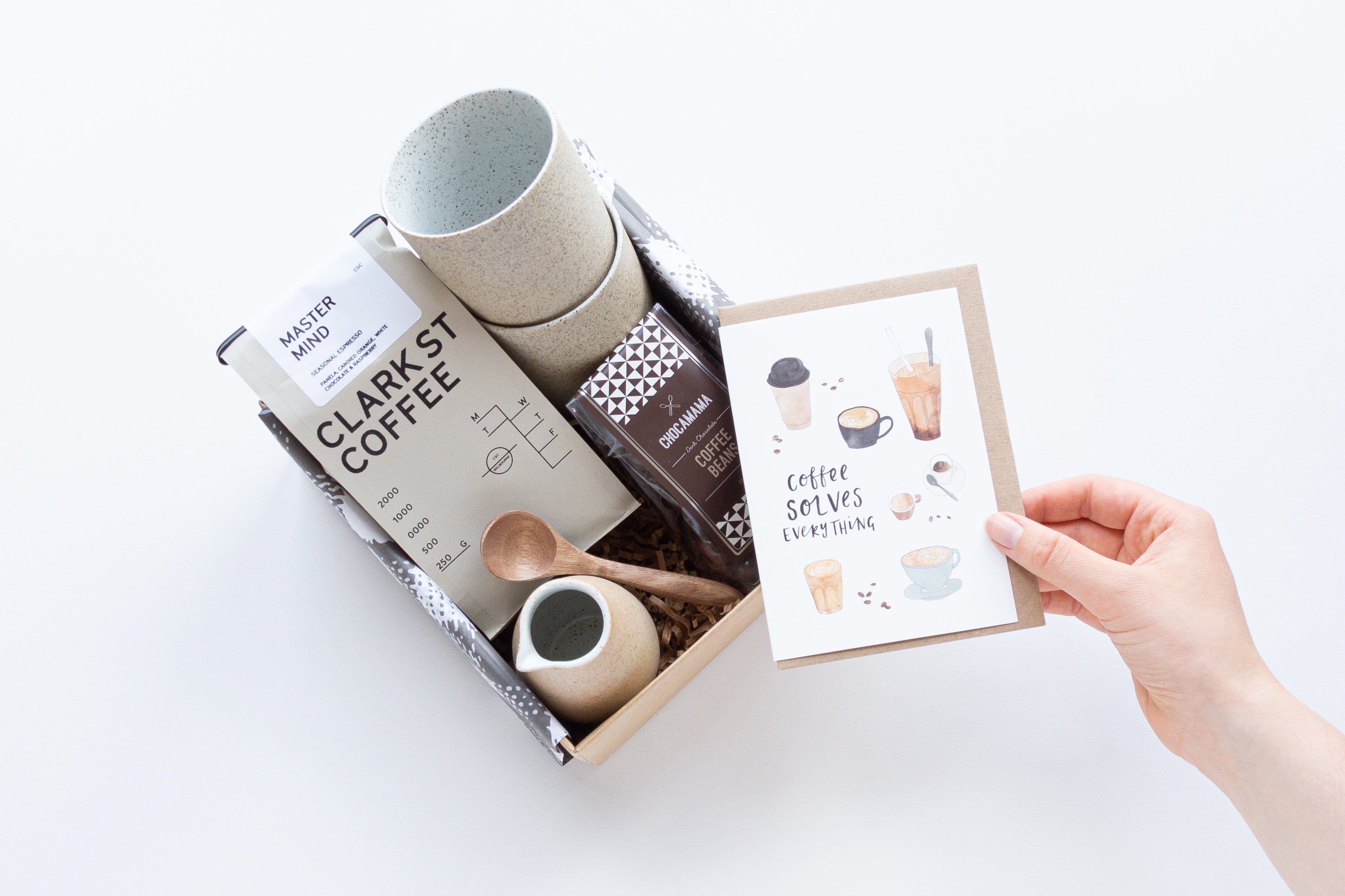 Gift box with coffee beans, cup, and card on a light background for Bindle gift hamper