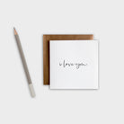 Greeting card with 'i love you' text and brown envelope on a white background