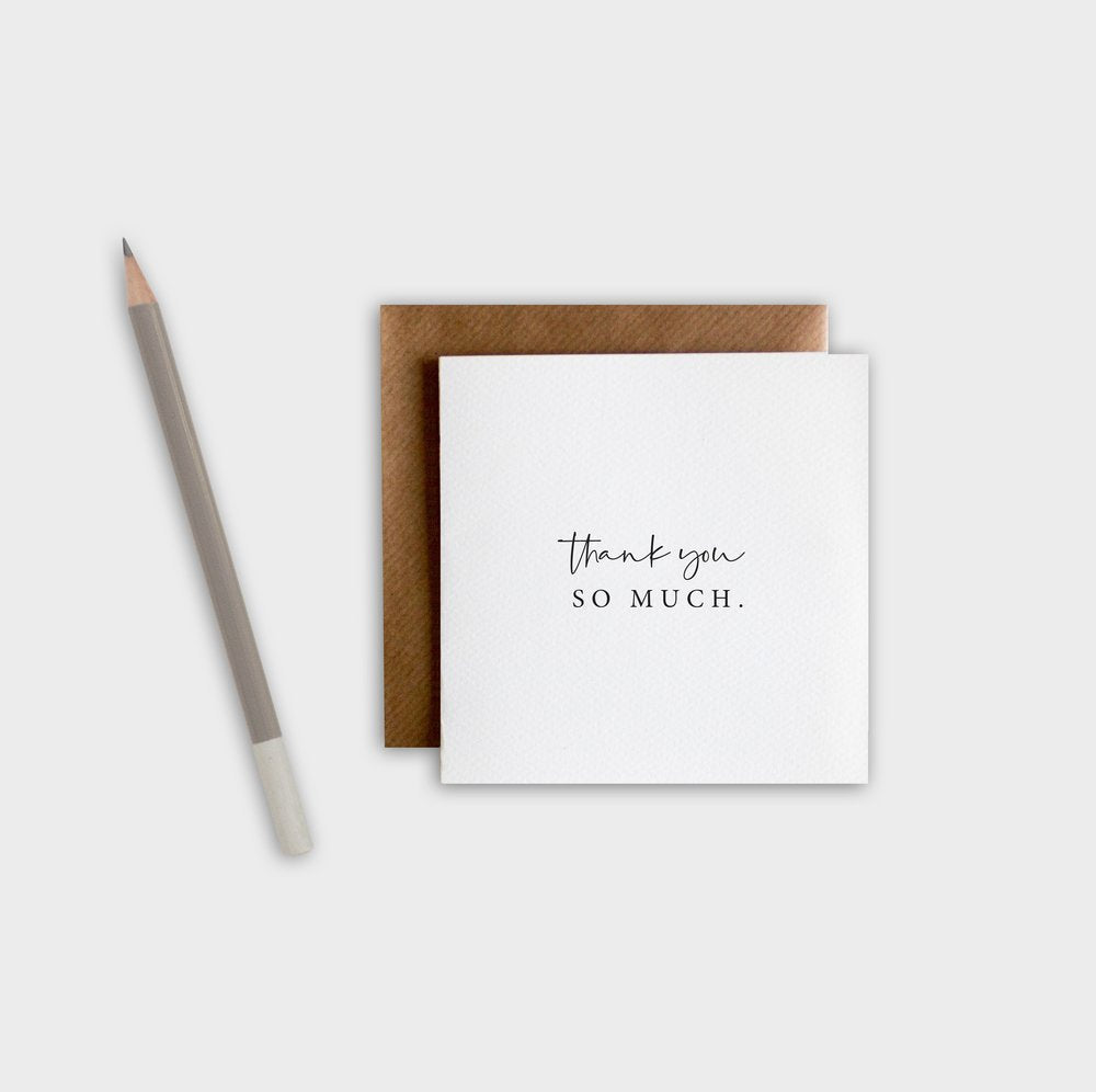 White card with 'thank you SO MUCH.' text, brown envelope, and pencil on a white background